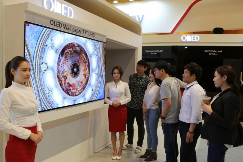 IMID 2017에 참가한 관람객들이 LG디스플레이 부스에서 77인치 UHD 월페이퍼 OLED를 감상하고 있다.